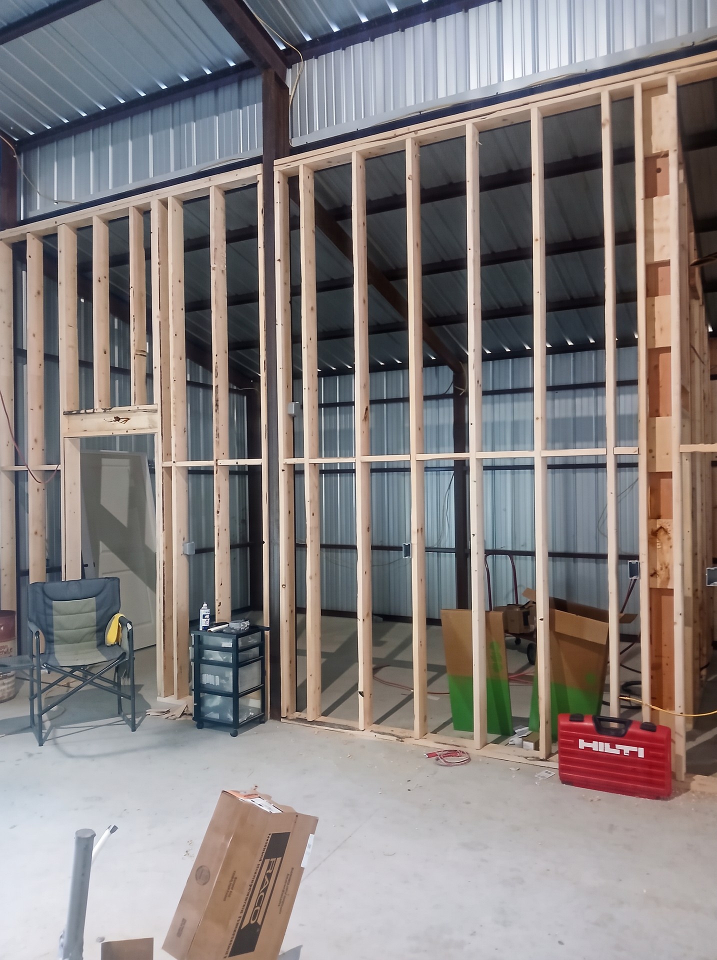 Wood wall framing inside a metal building