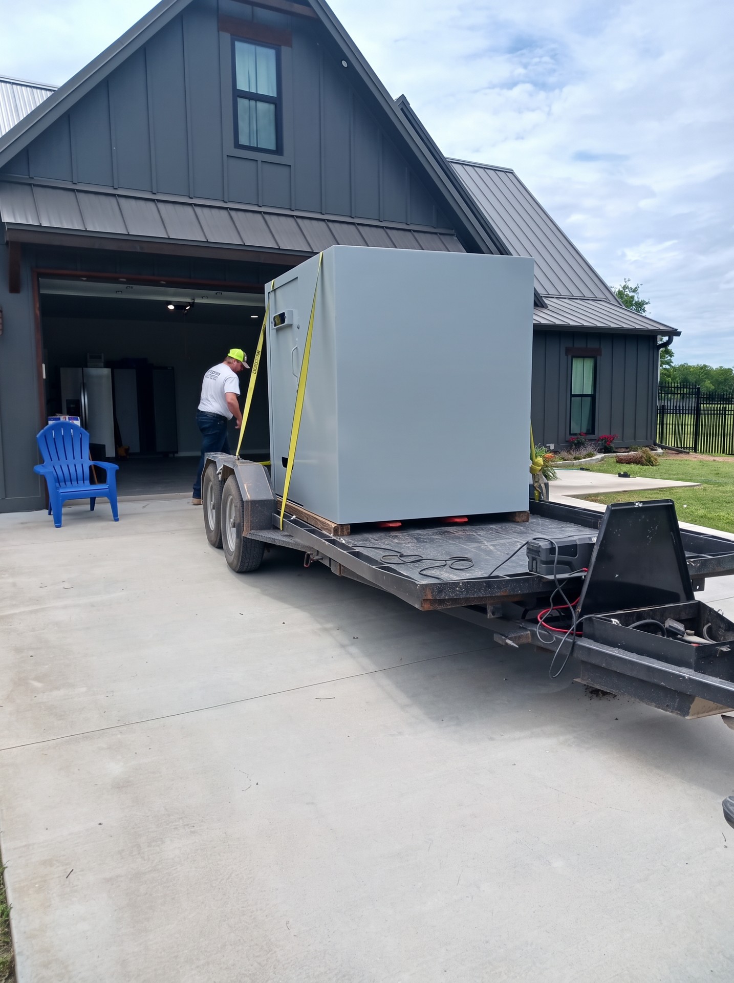 Safe room secured on a trailer outside a home
