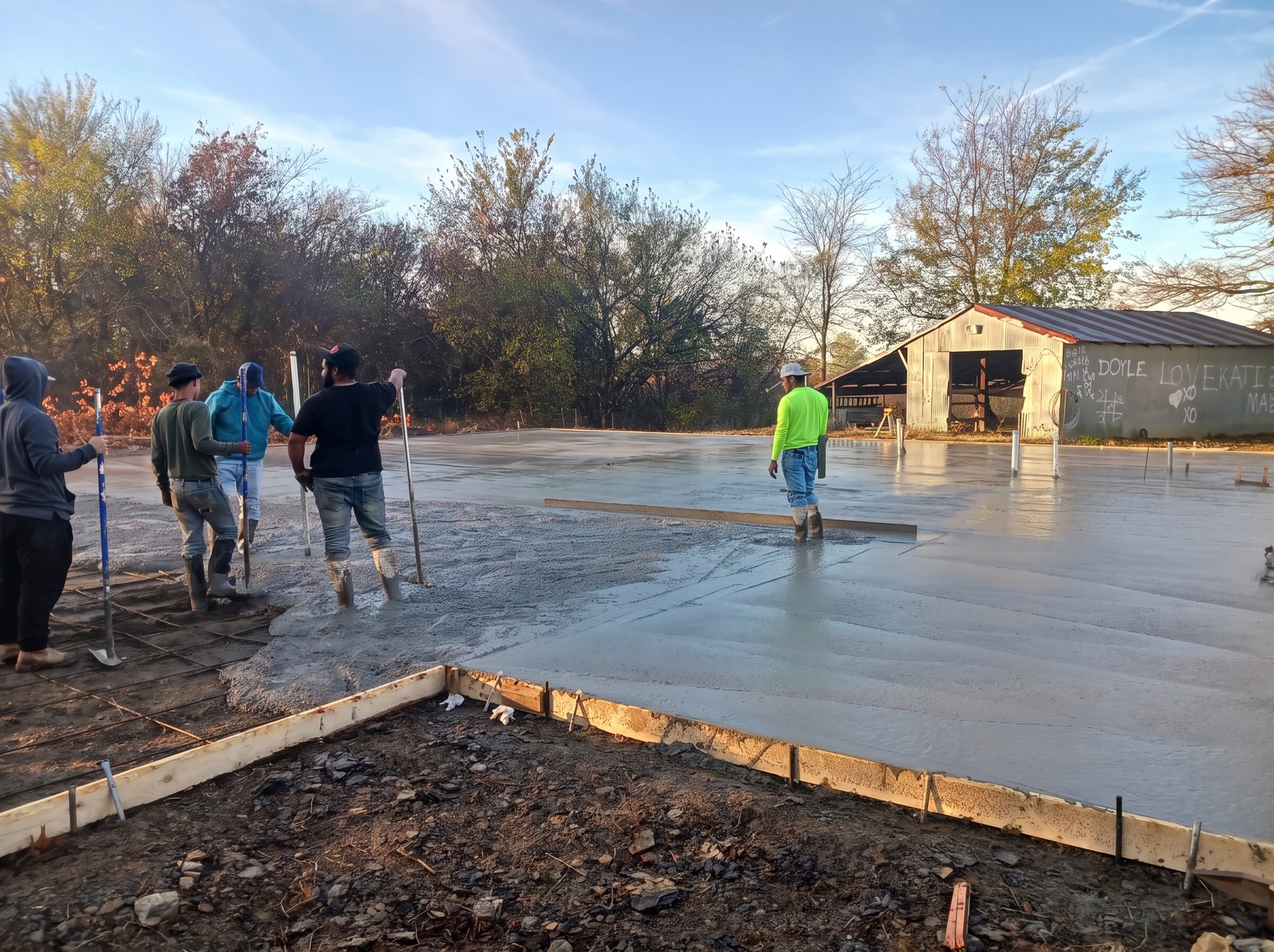 Crew placing and finishing a concrete slab